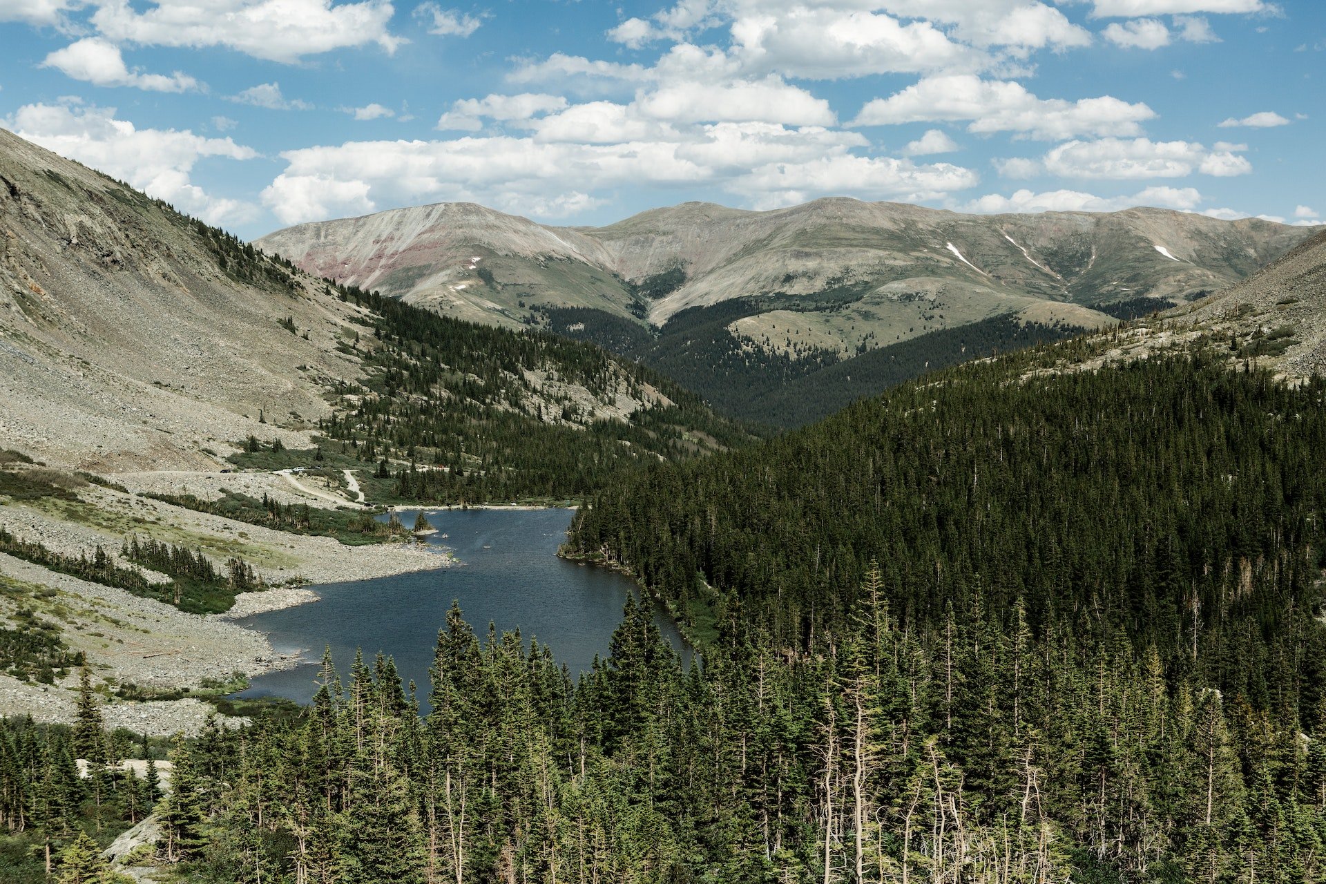 view of a mountainscape under cloudy blue sky